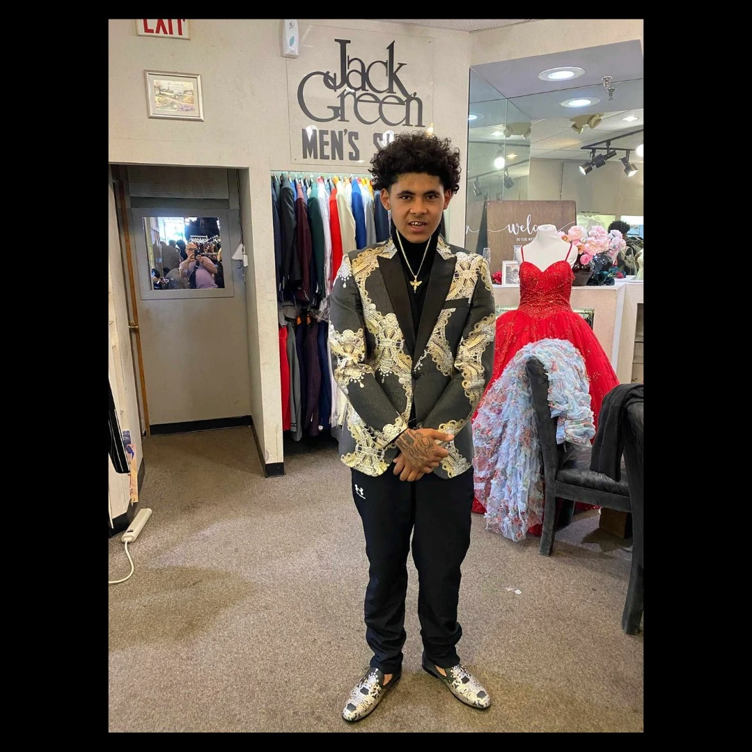 Client in black and gold embroidered blazer with matching patterned loafers