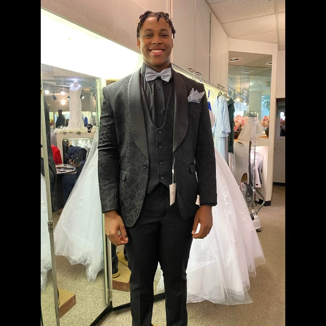 Client in black paisley three-piece tuxedo with silver bow tie and pocket square