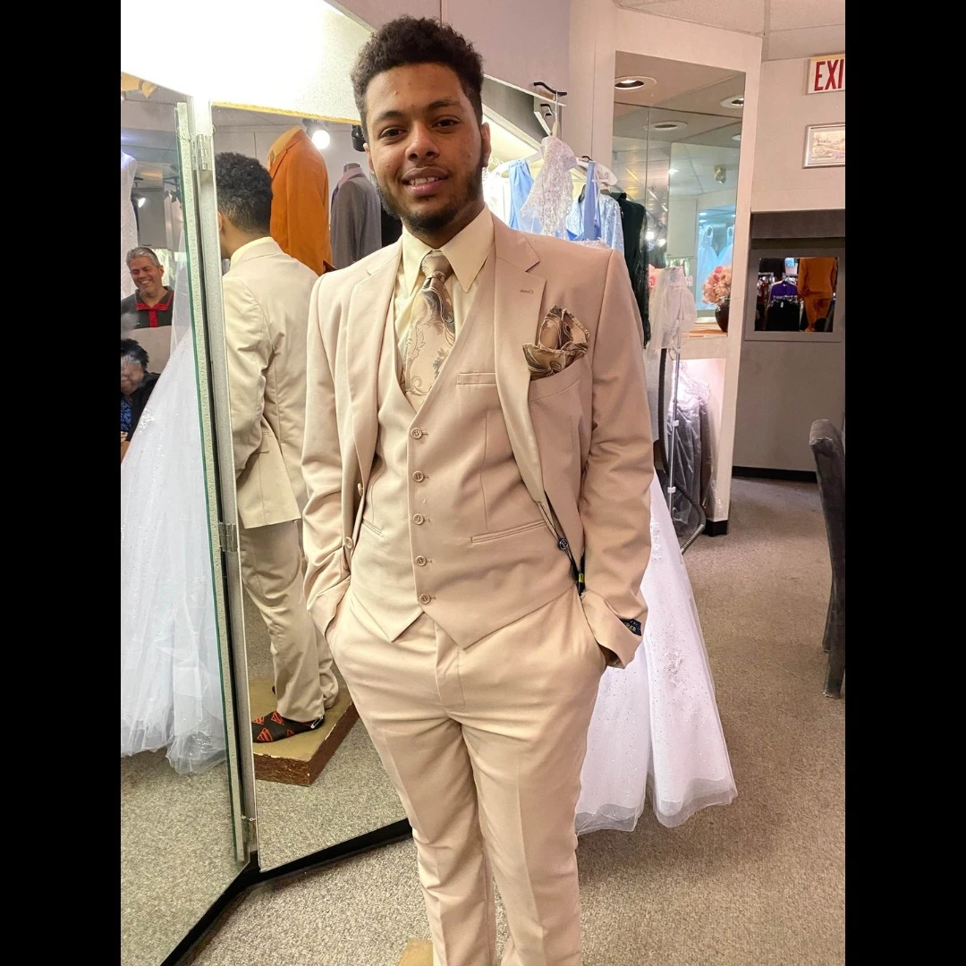 Client in champagne three-piece suit with paisley tie and pocket square