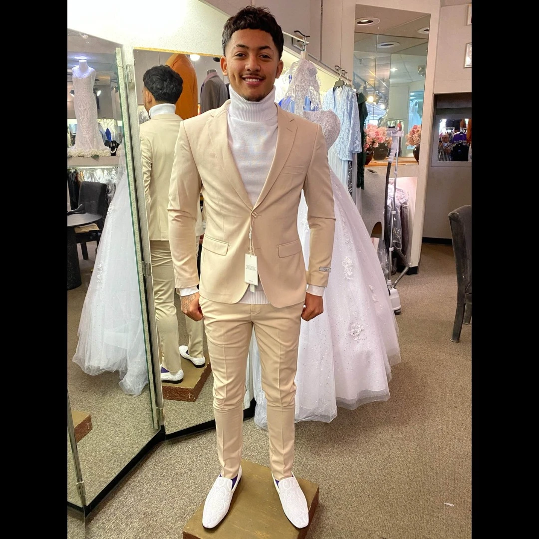 Client in cream suit with white turtleneck and white loafers