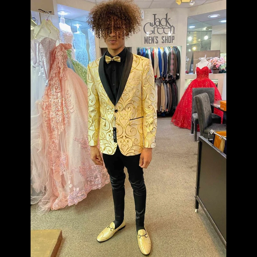 Client in gold brocade blazer with black lapel and matching gold loafers