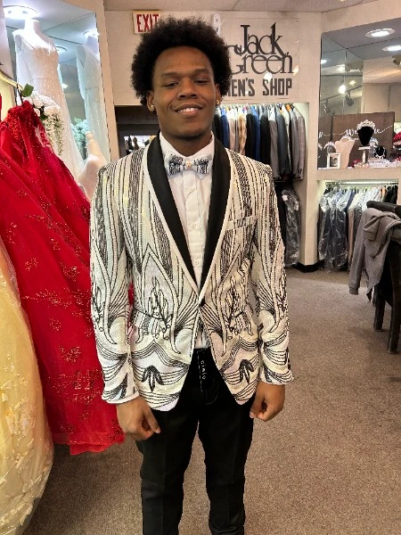 Client in white and silver sequin blazer with black lapel and matching bow tie