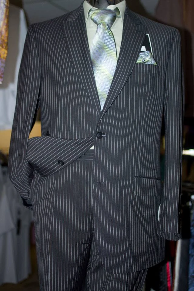 Black pinstripe suit with silver tie and pocket square