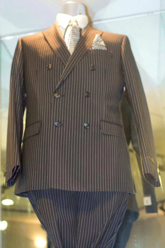 Brown pinstripe double-breasted suit with patterned tie