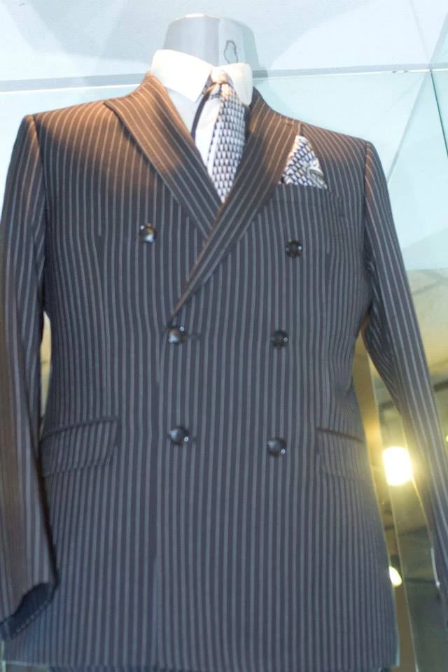 Charcoal pinstripe double-breasted suit with geometric tie