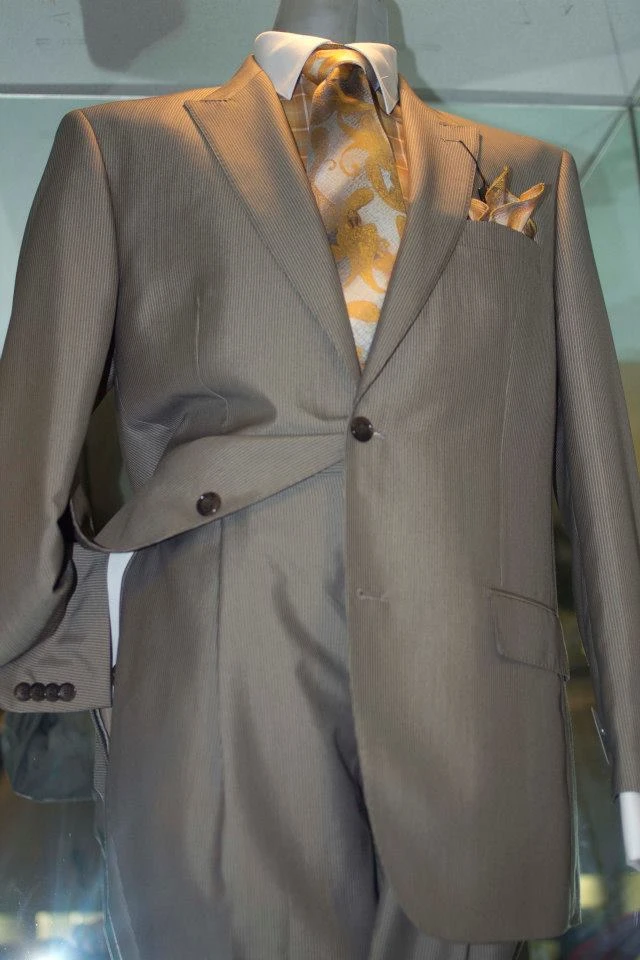 Olive tan suit with baroque patterned tie and pocket square