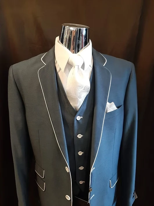 Steel blue three-piece suit with white piping and satin ascot tie