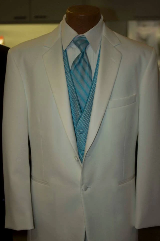White three-piece suit with teal vest and matching tie